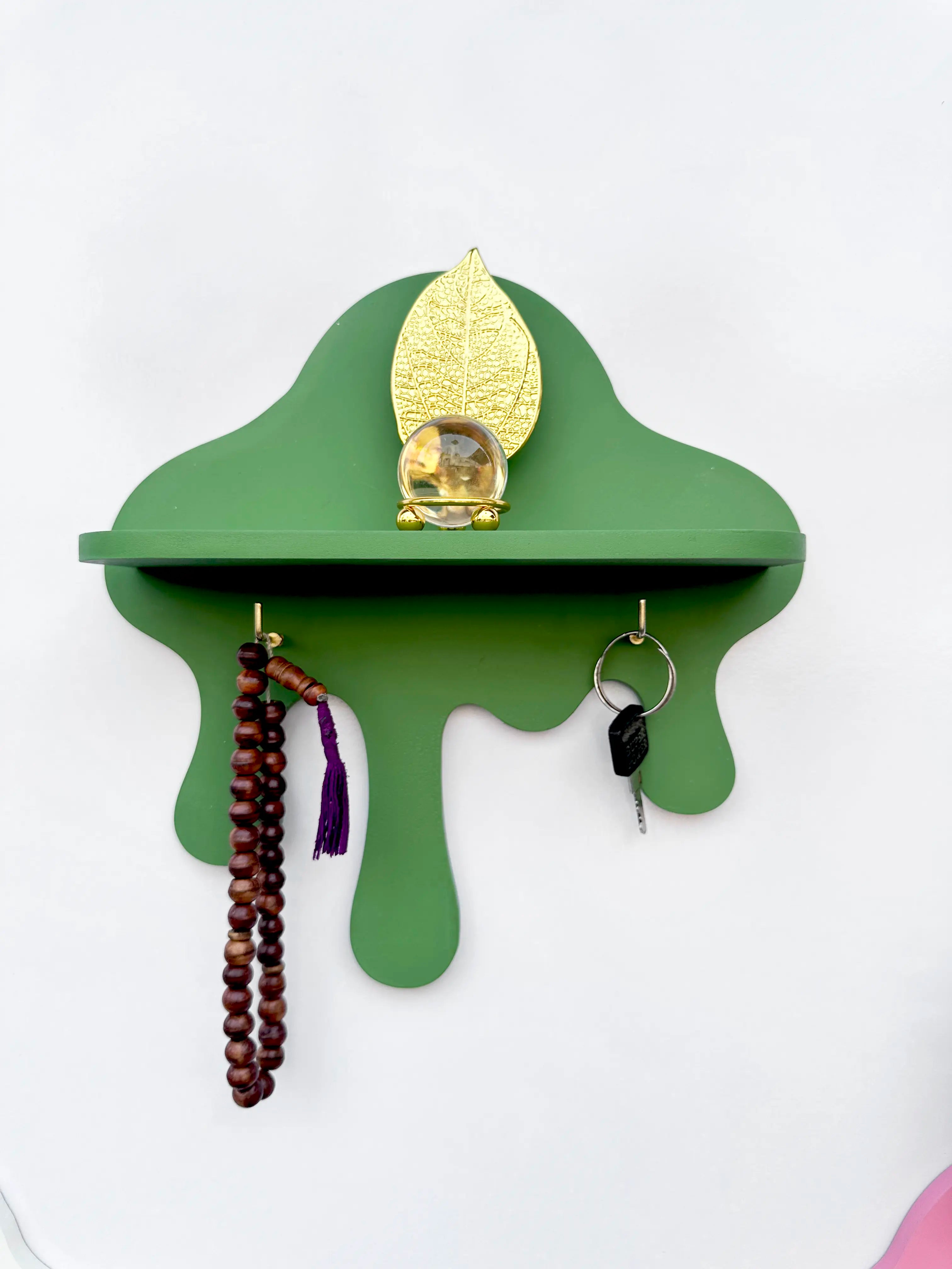 Green drip wall shelf with golden key hooks